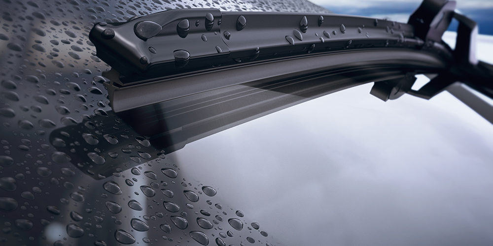 Car windshield with rain drops and frameless wiper blade closeup. 3d render